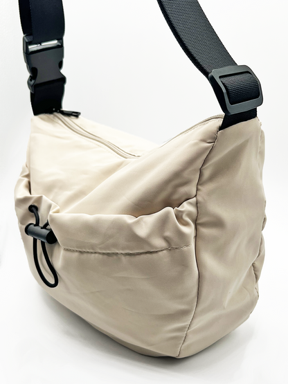 SVNX Nylon sling bag bag with drawstring front pocket in unbleached cotton